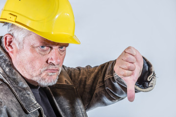 Portrait of a construction manager, pointing with his thumb down