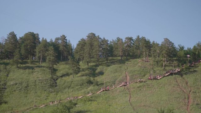 View of pathway in mountains with people on it going down