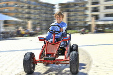 Young boy driving a Quadricycle