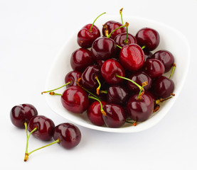 Cherry in a white plate on a white background