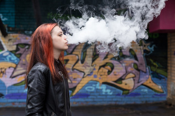 Young beautiful girl against graffiti