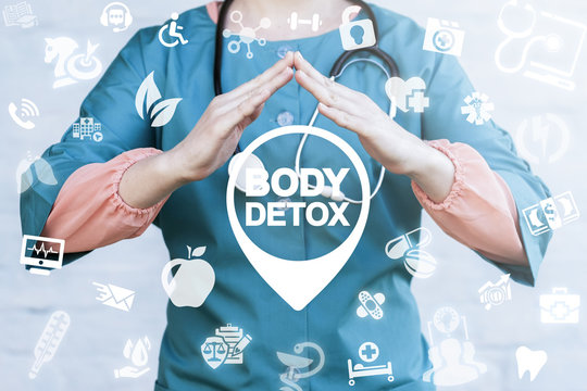 Body Detox Life Style Health Care concept. Doctor holds hands over body detox location icon on a virtual graphical medical user interface.
