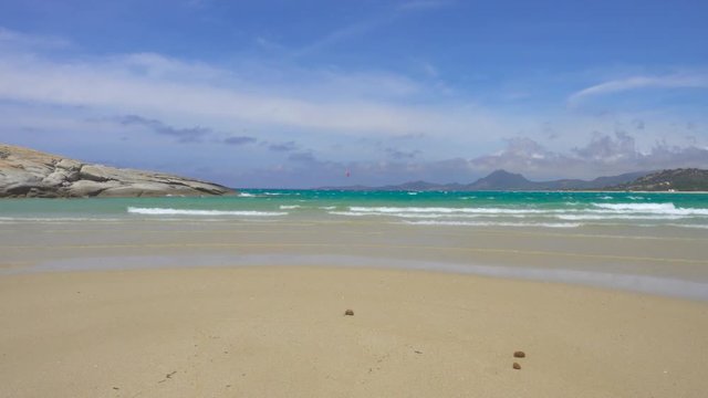 Kitesurfing and Windsurfing in a Windy Bay in Sardinia Italy