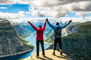 Couple standing against amazing nature view on the way to Trolltunga. Location: Scandinavian...