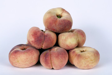 Flat peaches isolated on a white background