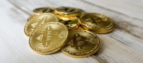 Golden Bitcoins on a wooden table. Photo new virtual money