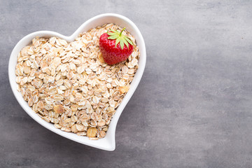 Dry rolled oatmeal in bowl.