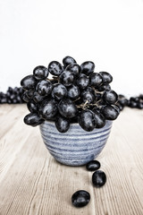 Black grapes in a bowl. Summer. Toned