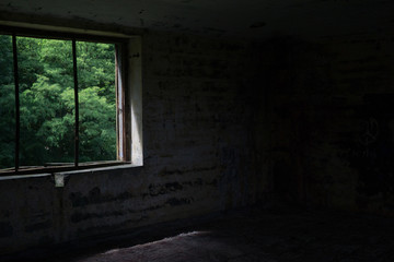 Fototapeta na wymiar old broken window in the neglected interior