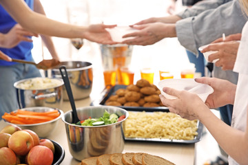 Volunteers giving food to poor people. Poverty concept