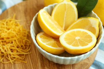 Bowl with sliced lemon, closeup