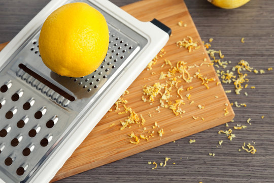 Grater and lemon on kitchen table