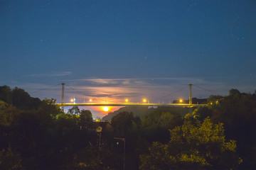 silhouette of bridge with moon