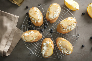 Grid with delicious sweet toasts on table