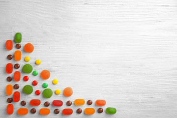 Different candies on wooden background