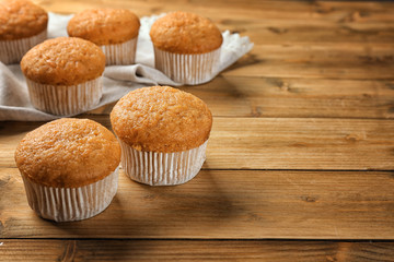 Delicious carrot muffins on wooden table