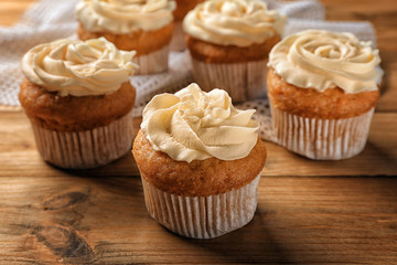 Delicious carrot muffins on wooden table