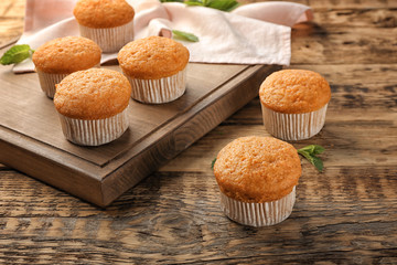 Delicious carrot muffins on wooden table