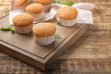 Delicious carrot muffins on wooden table