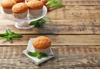 Composition with delicious carrot muffins on wooden table