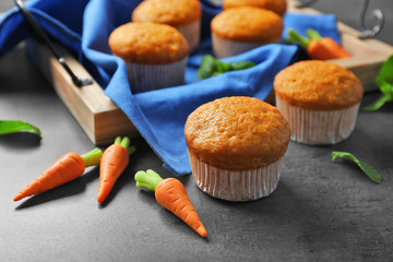 Composition with delicious carrot muffins on grunge table