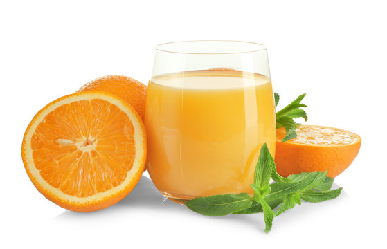 Composition with glass of fresh juice and oranges on white background
