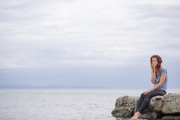 Fototapeta na wymiar Woman alone and depressed at seaside