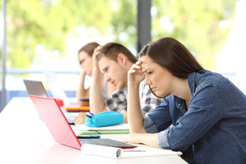 Frustrated students learning on line in a classroom