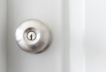 white door with metal doorknob is regular lock style in a house. - obrazy, fototapety, plakaty