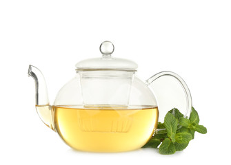 Teapot of hot aromatic tea with lemon balm on white background