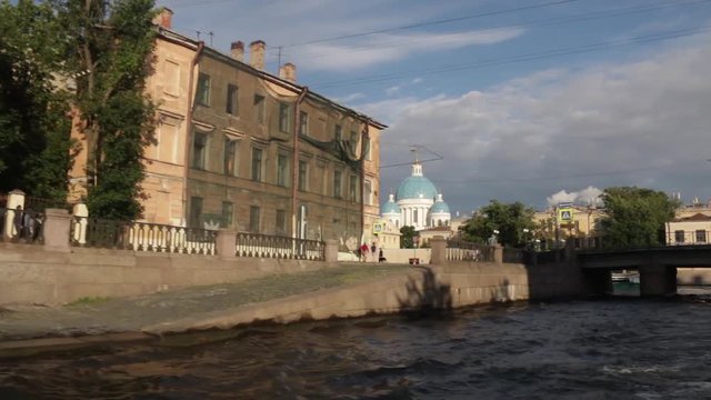 Boat trip on the rivers and Chanels of St. Petersburg. Tourists making photos on boat. Saint Petersburg in summer time.