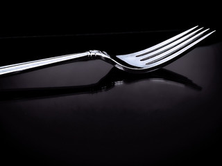 Silver utensils on a black background