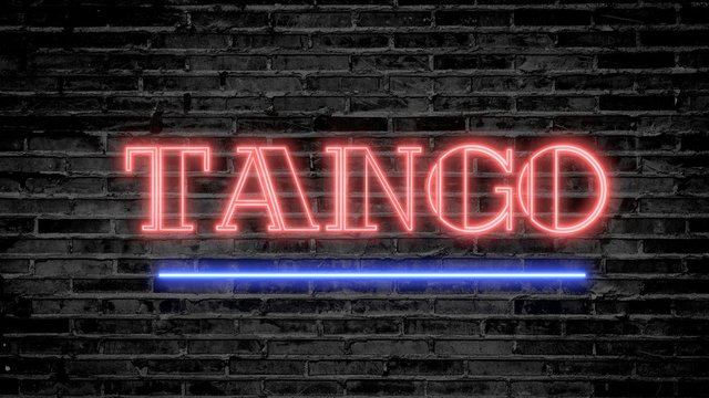 Tango neon sign on dark brick wall - background image