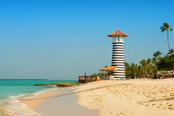 Fotobehang Striped red white lighthouse on the coast of the Caribbean Sea. Dominican Republic. © Yarkovoy