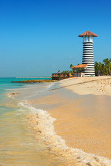 Striped red white lighthouse on the coast of the Caribbean Sea. Dominican Republic.