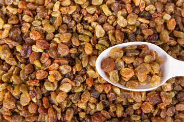 raisins and wooden spoon close- up food background