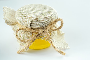 Golden honey in small glass jar