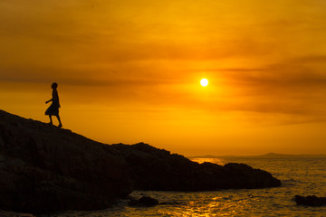 Fototapeta premium Man climbing at sunset