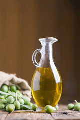 Olive oil and olives on wooden rustic table