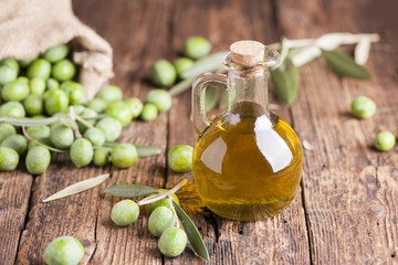 Olive oil and olives on wooden rustic table