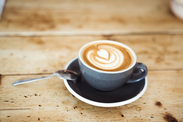 Cappuccino on wooden table 