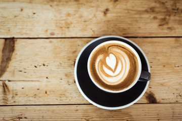 Cappuccino on wooden table 