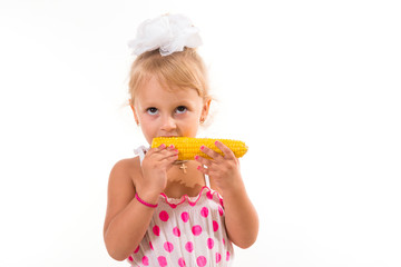 Young funny girl eating a boiled corn