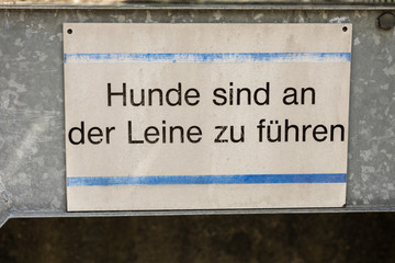dog on leash sign in german