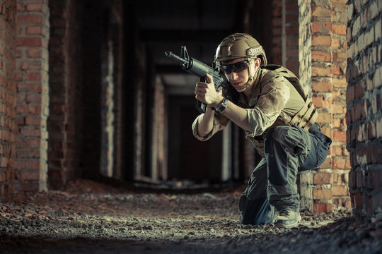 airsoft soldier with a rifle playing strikeball In brick building