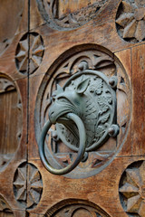 Antique door knocker shaped monster's head.