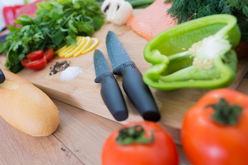 Fresh vegetables on wooden background with knife