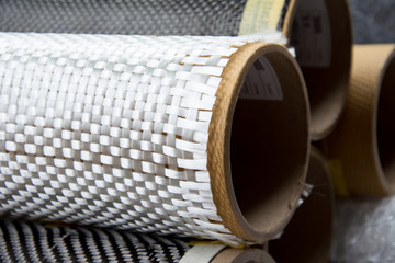 Black carbon fiber composite raw material close up background