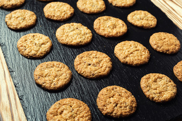 Biscuit sweet cookie background. Domestic stacked butter biscuit pattern concept,close up macro.Homemade cookies on wooden table.Cereal biscuits with the sesame,peanuts,sunflower and amaranth.
