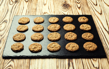 Biscuit sweet cookie background. Domestic stacked butter biscuit pattern concept,close up macro.Homemade cookies on wooden table.Cereal biscuits with the sesame,peanuts,sunflower and amaranth.